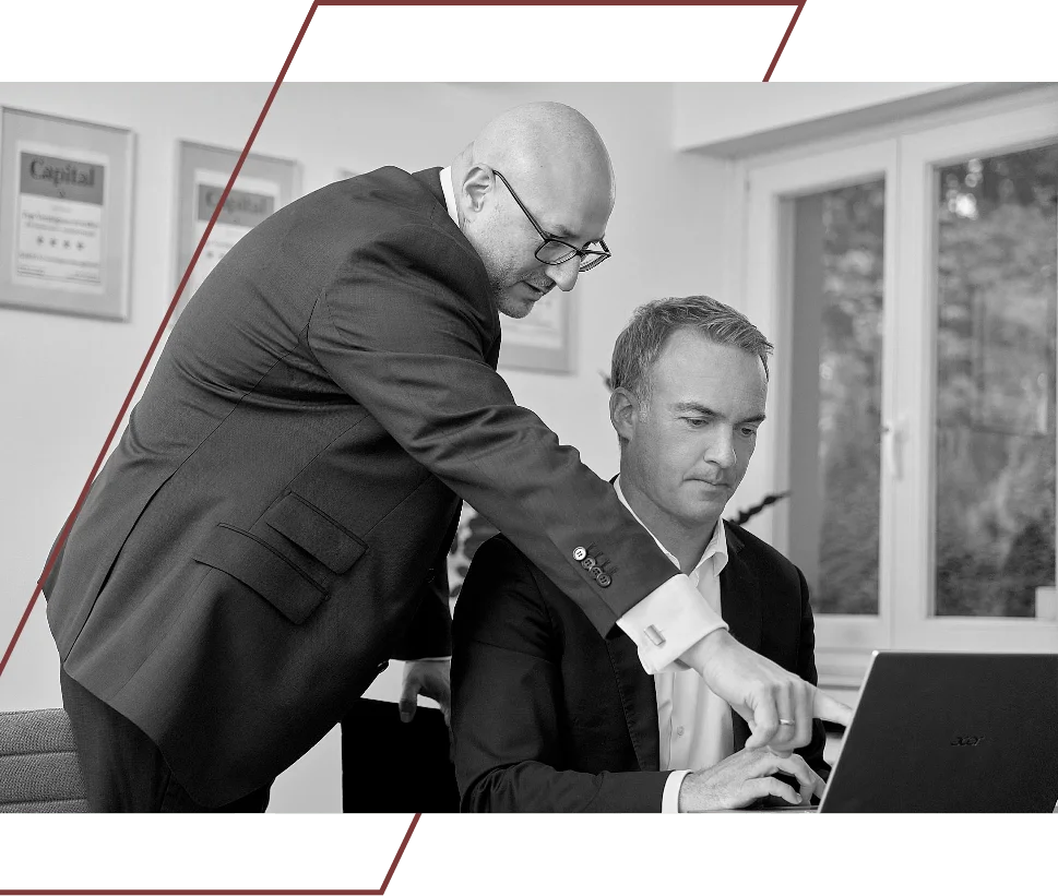 ein Mitarbeiter zeigt auf einen Bildschirm